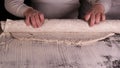 A little boy on a black background helps his father dad chef, preparing the dough to roll out for the pizza buns bread cakes and Royalty Free Stock Photo