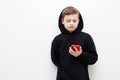 Little boy in a black hood with a smartphone