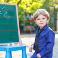 Little boy at blackboard learning to write Royalty Free Stock Photo