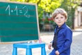 Little boy at blackboard learning to write Royalty Free Stock Photo