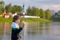 Little boy blowing dandelion on sunset on river shore Royalty Free Stock Photo