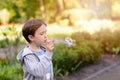 Little boy blowing soap bubbles in the park Royalty Free Stock Photo