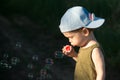 Little boy blowing soup bubbles