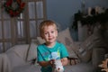 Little boy in a blu t-shirt waiting for Christmas