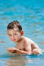 Little boy in blue sea Royalty Free Stock Photo