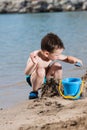 Little boy in blue sea and sand play Royalty Free Stock Photo