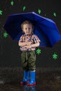 Little boy with blue umbrella on background of Royalty Free Stock Photo