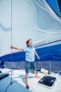 Little boy on board of sailing yacht on summer cruise. Travel adventure, yachting with child on family vacation. Royalty Free Stock Photo