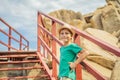 Little boy on boardwalk with stairs to the beach, vacation concept Royalty Free Stock Photo