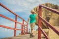 Little boy on boardwalk with stairs to the beach, vacation concept Royalty Free Stock Photo