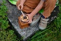 a little boy borrowed a manual coffee grinder and grinded biscuits.