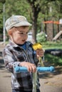 Little boy with a bouquet of yellow dandelions. Royalty Free Stock Photo