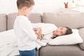 Little boy bring glass of water for sick sister