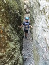 A little boy in the Broken Heart stone, near the Demerdzhi tract. Crimea 2021 Royalty Free Stock Photo