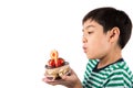 Little boy browing candle on the cake for his birthday Royalty Free Stock Photo