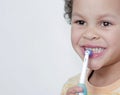 Boy brushing his teeth with an electric tooth brush stock image with grey background stock photo