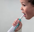 Little boy brushing his teeth with an electric tooth brush stock photo
