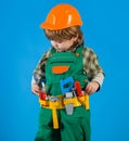 Little boy in builders uniform with tool belt. Tools for building. Kid repairman. Child game. Royalty Free Stock Photo