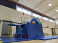 Little boy building a base fort out of mats and sticks Royalty Free Stock Photo