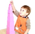 Little boy builds a pink tower