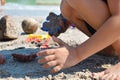 A little boy builds a sand castle. Playing with sand and toys for the ocean. A holiday with the kids at the resort.