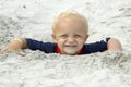 Little Boy Buried in Sand up to Head Royalty Free Stock Photo