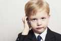 Little boy in business suit with cell phone. handsome child. fashionable kid Royalty Free Stock Photo