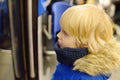 Little boy in a cabin of subway or tram car. Child passenger of comfortable transport of big city. Urban infrastructure Royalty Free Stock Photo
