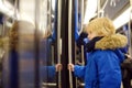 Little boy in a cabin of subway or tram car. Child passenger of comfortable transport of big city. Urban infrastructure Royalty Free Stock Photo