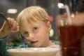 Little boy in a cafe eating dumplings