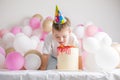 Little boy with Cake . Small child with party balloons, celebration. Birthday, happiness, childhood, look