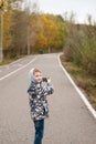 Little boy with camera in autumn Park,