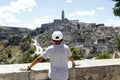 Little boy in cap look at beautiful Italian touristic historic Matera city