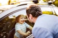 Little boy in the car, looking out of window at his father. Royalty Free Stock Photo