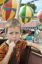 Little boy on a carrousel in amusement park Royalty Free Stock Photo