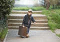 A little boy is carrying a big suitcase Royalty Free Stock Photo