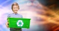 Little boy carrying recycle container