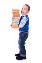 Little boy carrying stacked books