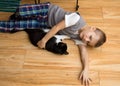 Little boy with a cat on the floor Royalty Free Stock Photo