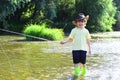 Little Boy Catching a Fish. Children fishing. Boy fishing in pond. Little boy fisherman with fishing rod. Royalty Free Stock Photo