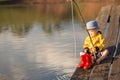 Little Boy Catching a Fish from wooden dock Royalty Free Stock Photo