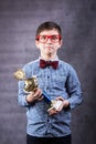 Little boy celebrates his golden trophy Royalty Free Stock Photo