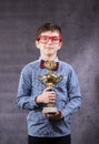 Little boy celebrates his golden trophy Royalty Free Stock Photo