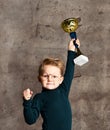 Little boy celebrates his golden trophy Royalty Free Stock Photo