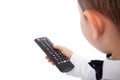 Little boy changing channels on TV using remote control, isolated on white. Empty space Royalty Free Stock Photo