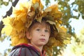 Little boy with chaplet of yellow leaves