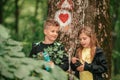 Little boy chatting with cute girl in forest