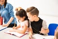 Little boy cheating in class Royalty Free Stock Photo