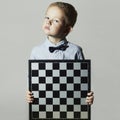 Little boy with chessboard.Little genius Child