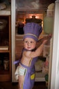 Little boy in a chief hat standing near refrigerator Royalty Free Stock Photo